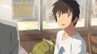 Young man smiling in front of window — Your Name