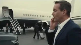 man in suit talking on phone by airplane — Succession