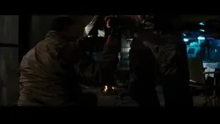 Two men working metal in dark room — Batman: The Dark Knight Rises