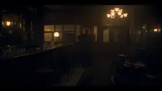 man standing in dimly lit bar — Peaky Blinders