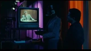 two men with headphones watching TV — Joker