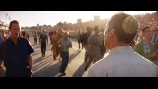 man in blue shirt on busy street — Ford v Ferrari