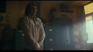 Man standing in cluttered room — Joker