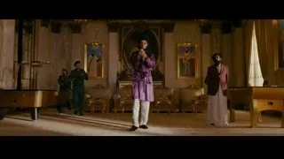 man in purple robe holding microphone — The Dictator
