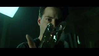 man wearing metallic gold glove in spotlight — The Matrix