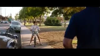 boy riding bicycle on sidewalk — Ford v Ferrari