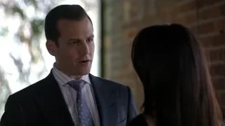 man in suit conversing with woman outdoors — Suits