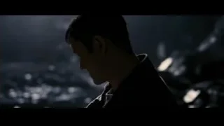 young man standing in stormy environment — Batman: The Dark Knight Rises