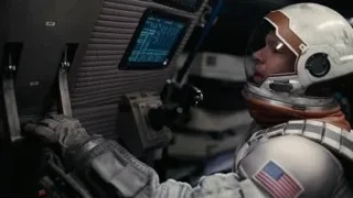 Astronaut in cockpit operating controls — Interstellar