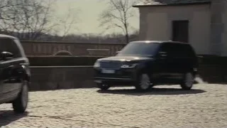 black Range Rover on cobblestone street — Succession