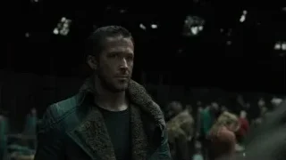 man in dimly lit room with crowd — Blade Runner 2049