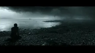 person sitting on rocky beach — Gladiator 2