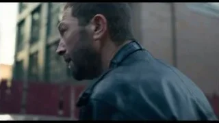 man's face in urban area — The Bear