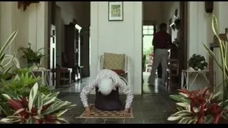 young boy in white cap sitting in hallway — Life of Pi