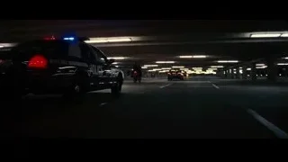 police car parked in parking garage — Batman: The Dark Knight Rises