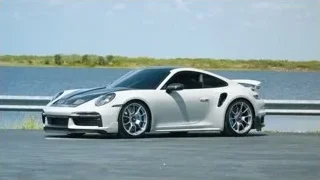 white Porsche parked near water — Sports Cars