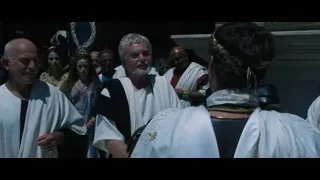 Man in white robe addressing temple crowd — Gladiator