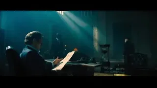 man reading paper at desk in dark room — John Wick: Chapter 4