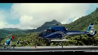 blue helicopter flying over mountains with people — Jurassic World