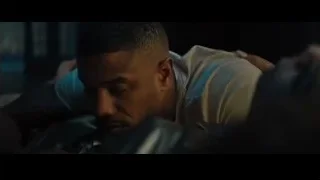 man lying on a bed in dark room — Creed 2