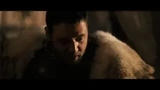 man in fur coat in dimly lit room — Gladiator