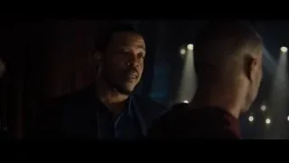 two men talking in dimly lit room — Creed 2