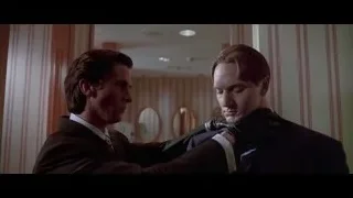 Man in suit adjusting other man's collar — American Psycho