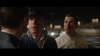 men talking in dim room cityscape — Ford v Ferrari