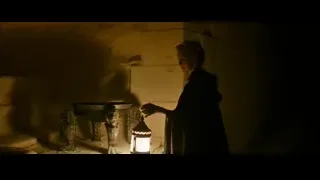 person holding lantern in dimly lit room — Gladiator 2