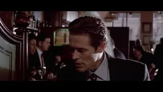 man in suit sitting at restaurant table — American Psycho