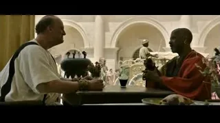 two men at table with arches — Gladiator 2