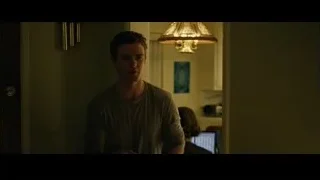 young man standing in dimly lit room — The Social Network
