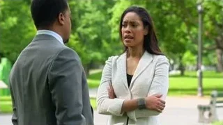 Man gesturing to woman in park — Suits