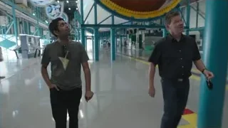 Two men walking in large indoor space — Elon Musk: Return to Space