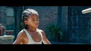 young girl standing in front of brick building — The Karate Kid