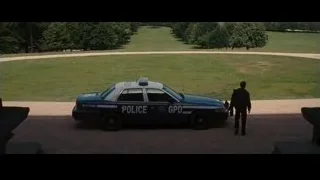 police car parked in park with driver — Batman: The Dark Knight Rises