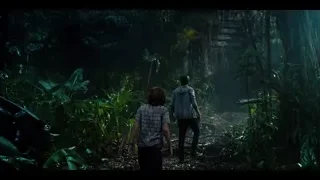Two people walking through dense jungle — Jurassic World