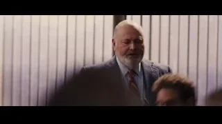 two men, one bald, arguing and shouting — The Wolf Of Wall Street