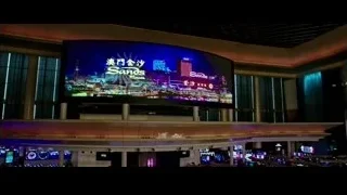 interior of large casino with Sands Casino screen — Now You See Me 2