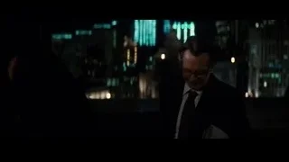 Man in suit before city skyline at night — Batman: The Dark Knight Rises