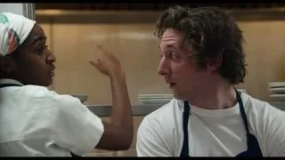 Man and woman in kitchen with serious expressions — The Bear