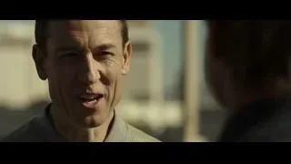 man's face looking at camera outdoors — F1