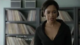 woman with serious expression by bookshelf — Suits