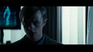 man in suit with serious expression in dim room — The Amazing Spider Man 2