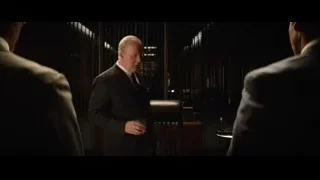 Men in suits in dimly lit room — Ford v Ferrari