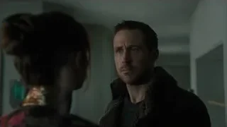 man in fur collar facing woman in dim room — Blade Runner 2049