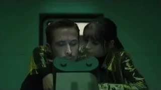 man and woman with green object — Blade Runner 2049