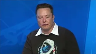 Elon Musk at press conference with SpaceX logo — Elon Musk: Return to Space