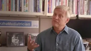 Older man speaking in library — Screened Out
