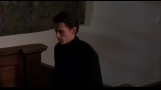 Man in dimly lit room with tapestry — Spider Man